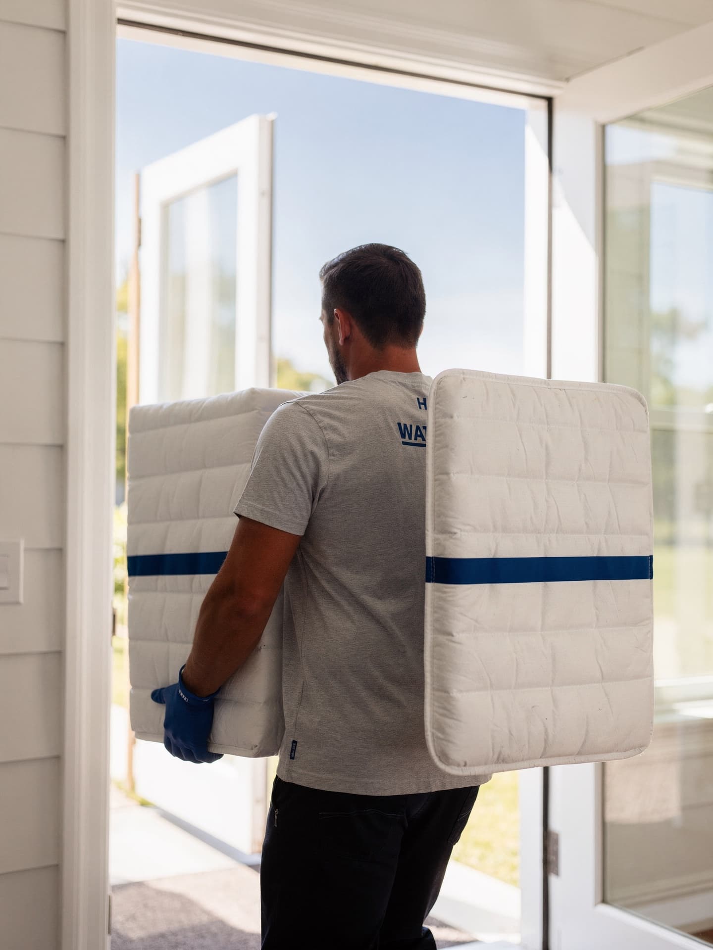 Movers carefully carrying furniture into a home